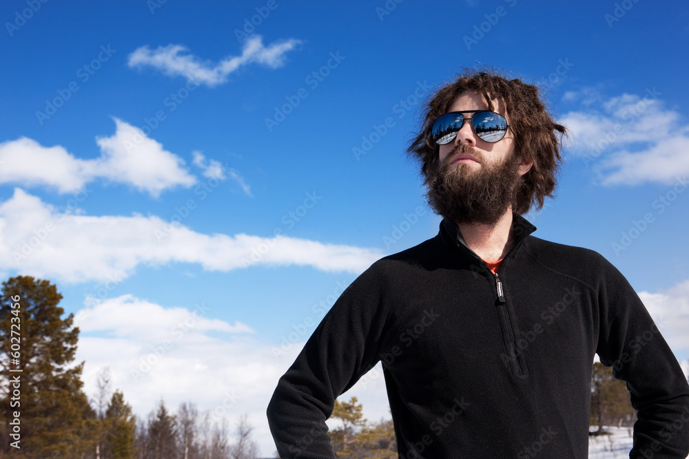 A male standing in a winter landscape ready for adventure A male standing in a winter landscape ready for adventure