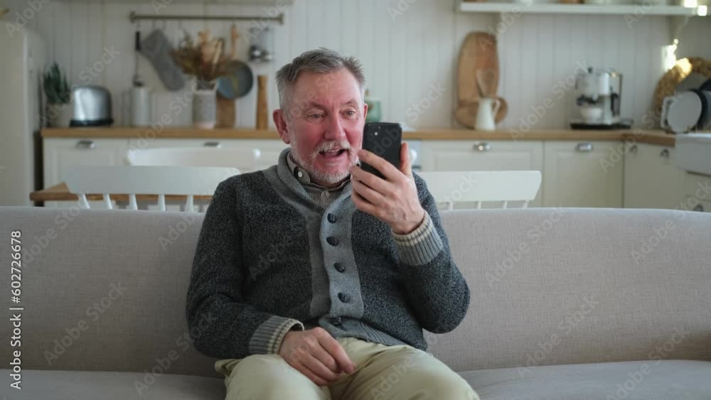 Happy middle aged senior man talk on video call with friends family. Laughing mature old senior grandfather having fun speaking with grown up children online. Older generation modern tech usage Happy middle aged senior man talk on video call with friends family. Laughing mature old senior grandfather having fun speaking with grown up children online. Older generation modern tech usage