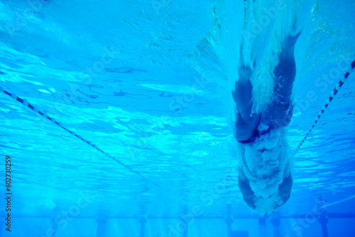 undervater shoot of swimming pool with good looking young swimmer photo