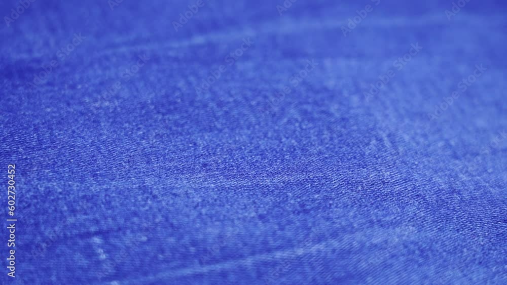 denim jeans cloth of blue colour lies on workshop table denim jeans cloth of blue colour lies on workshop table