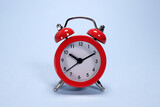Red alarm clock on a blue background