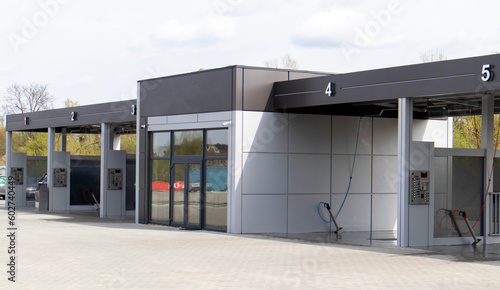 Self-service high-pressure car wash in the open air. Photo of an open self-service car wash. Manual car wash with pressurized water in a car wash outside.