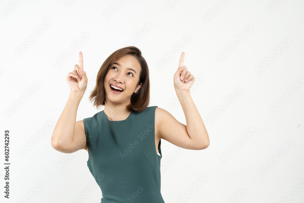 Young smiling Asian woman pointing finger sideways to copy space in white color background. Young smiling Asian woman pointing finger sideways to copy space in white color background.