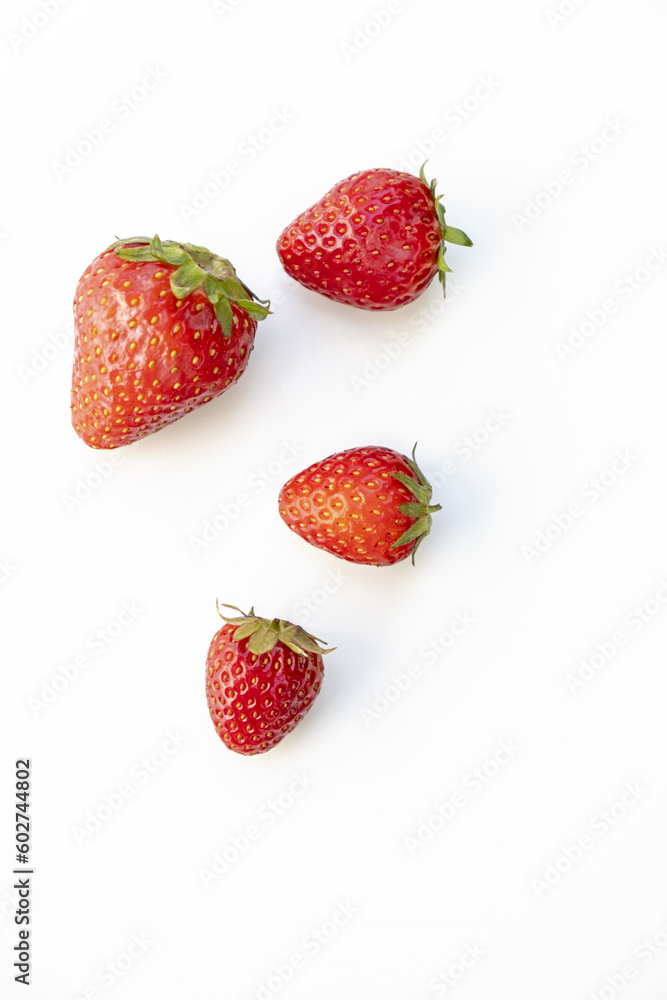 Group of four strawberries viewed from above on a white background Group of four strawberries viewed from above on a white background
