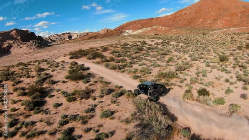 UTV driving on a dirt trail in the desert