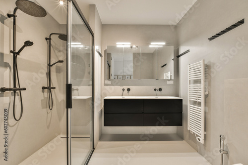 a modern bathroom with black and white fixtures on the walls, toiletries, sink, shower, and mirror