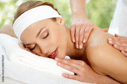 Young beautiful and relaxed lady taking spa treatment