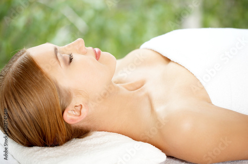 Young beautiful and relaxed lady taking spa treatment