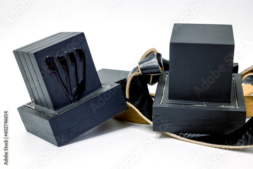 Tefillin  or  phylacteries . Pair of black leather boxes  for the arm and for the head with leather strips containing Torah verses that are worn Jewish men  prayers.  One box with hebrew letter Shin.
 photo