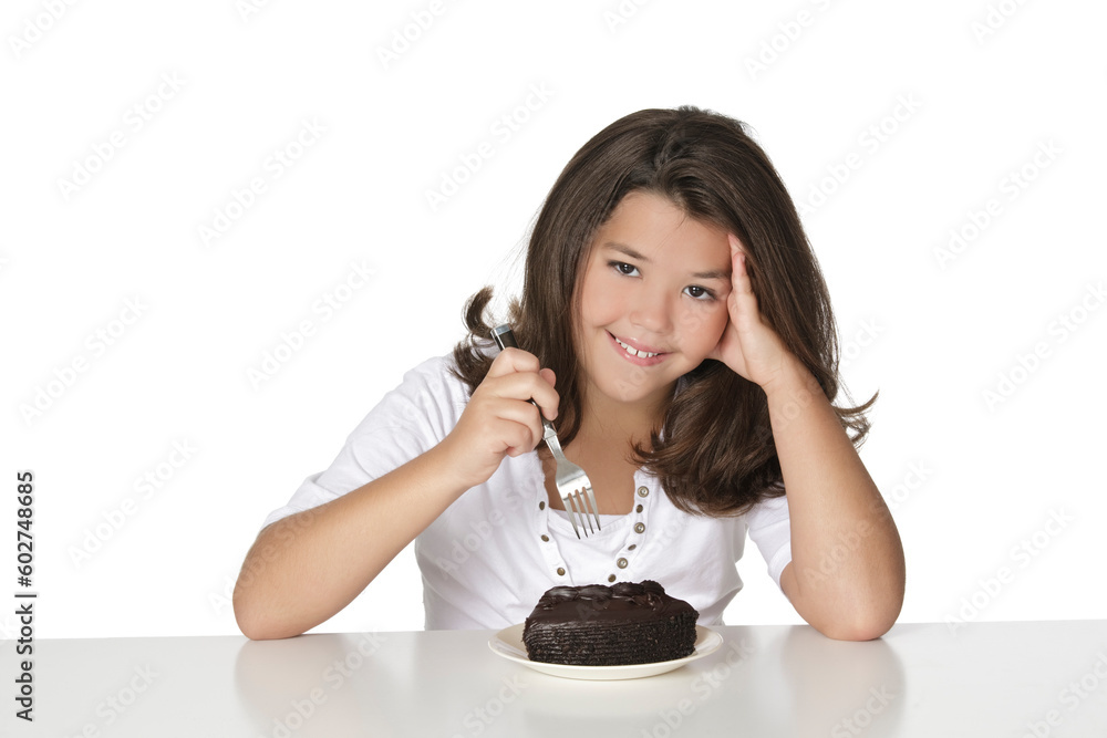 Cute Caucasian child eating a slice of chocolate cake Cute Caucasian child eating a slice of chocolate cake