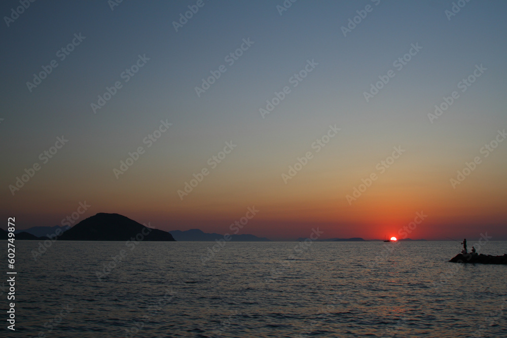 Tourists on holiday in the famous resort town of Bodrum spend time fishing at sunset. Tourists on holiday in the famous resort town of Bodrum spend time fishing at sunset.