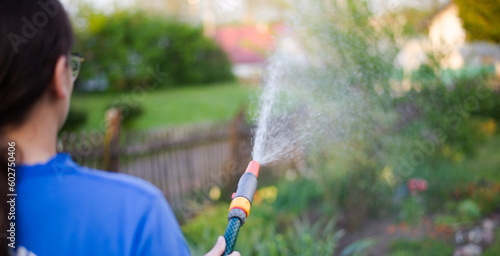 young woman watering flowers