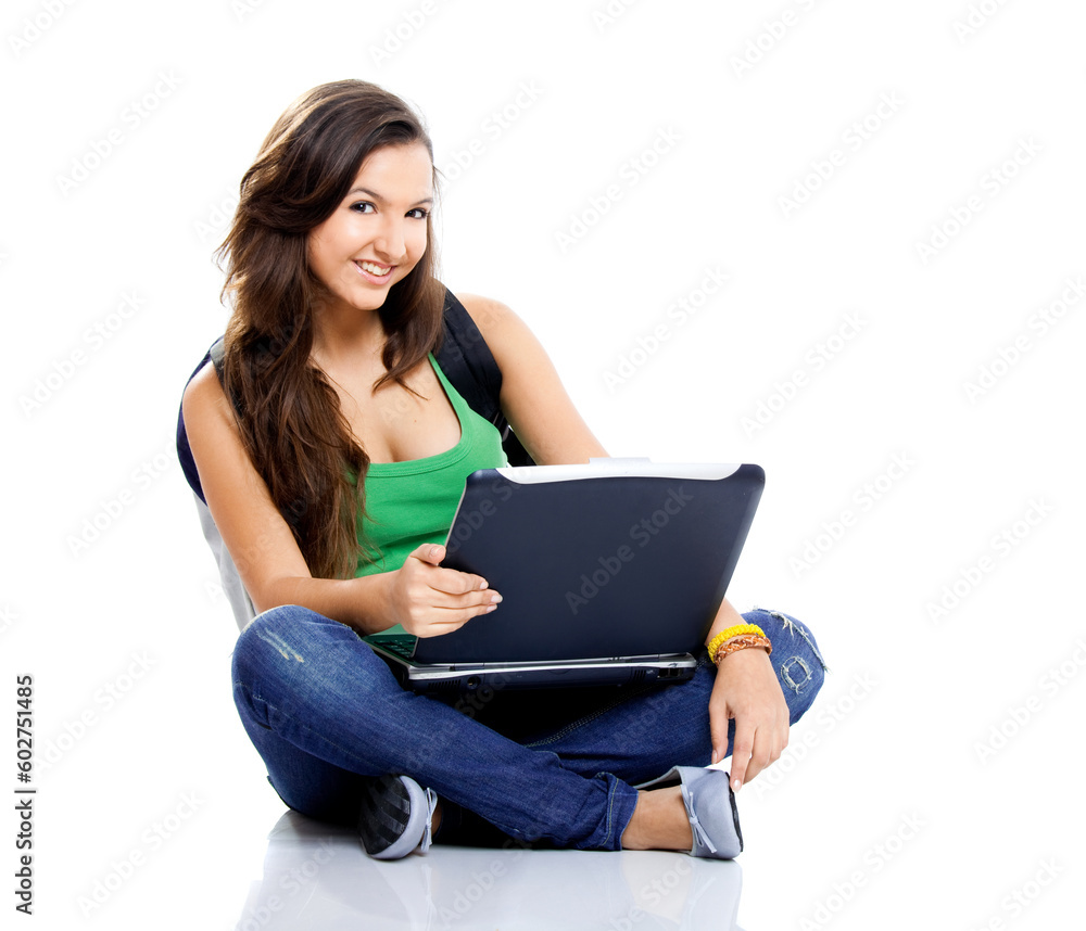 Beautiful young female student sitting on floor studying on a laptop, isolated on white Beautiful young female student sitting on floor studying on a laptop, isolated on white