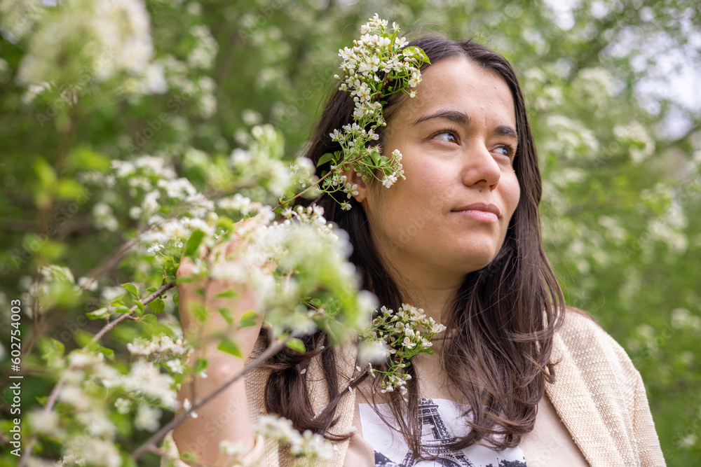 beautiful woman girl outside in park through blossom tree branches white small flowers.natural beauty no makeup female smiling holding flowers in palms.outdoor shooting spring time easter.brunette hai beautiful woman girl outside in park through blossom tree branches white small flowers.natural beauty no makeup female smiling holding flowers in palms.outdoor shooting spring time easter.brunette hai