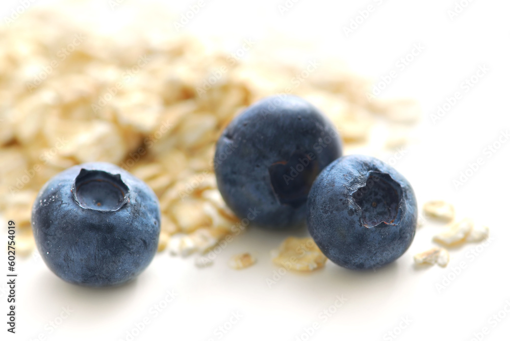 Blueberries and oats macro on white background Blueberries and oats macro on white background