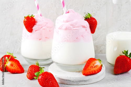 Whipped Strawberry Milk, Strawberry Milkshake, Dalgona Style Drink with Fresh Strawberry on Grey Background