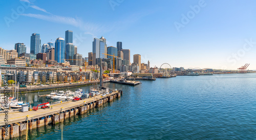 Panoramic view of the Seattle Waterfront along the Puget Sound with skyscrapers, the Pike Place Market district, the Great Wheel and Safeco Field in view from the harbor in Seattle Washington, USA.