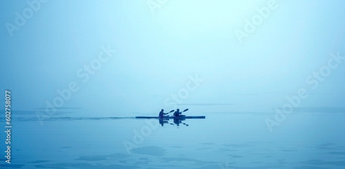 Wonderful quiet picture of two people canoeing very early in the morning. Image details: I have edited the contrast of this picture. I have not used any filters or noise reduction. The canoe is in