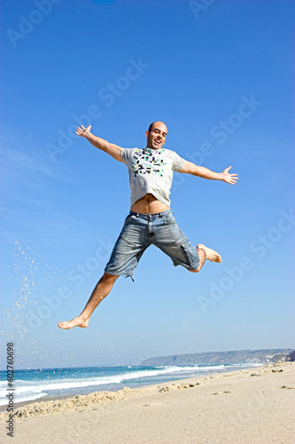 Man jumping on the beach and having fun