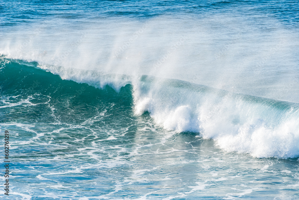 Fototapeta premium Big Waves crashing creating white foam that vaporises in the air. Sopelana beach near Bilbao. Day of relaxation and tranquility with little wind and incredible colors.