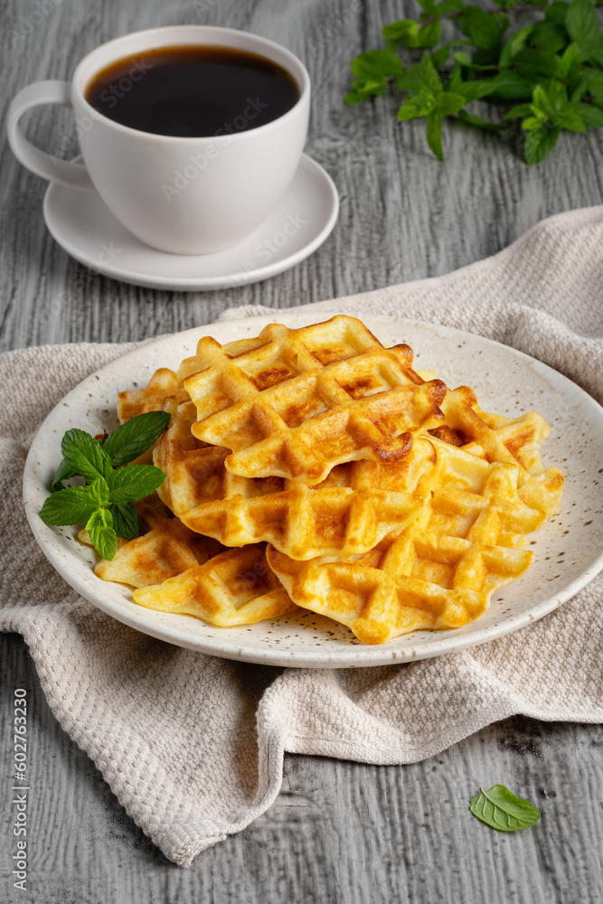 Belgian waffles and coffee on a gray background Belgian waffles and coffee on a gray background