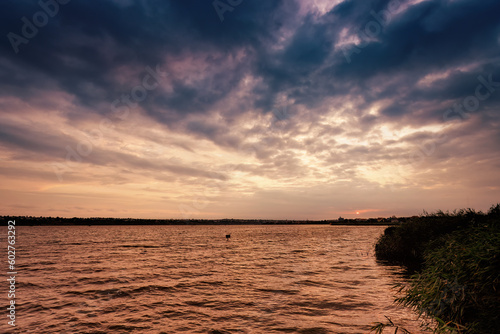 Fototapeta Naklejka Na Ścianę i Meble -  Romantic pink skies reflecting on a calm and serene lake