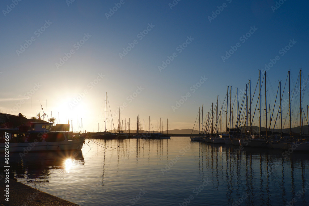 sunset at the marina of alghero, sardinia, italy