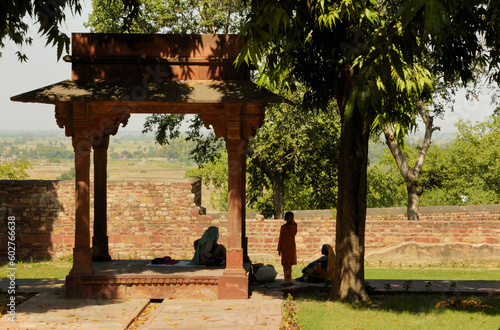 Photography photograph of ladies in the shade in a temple in Rajasthan, India