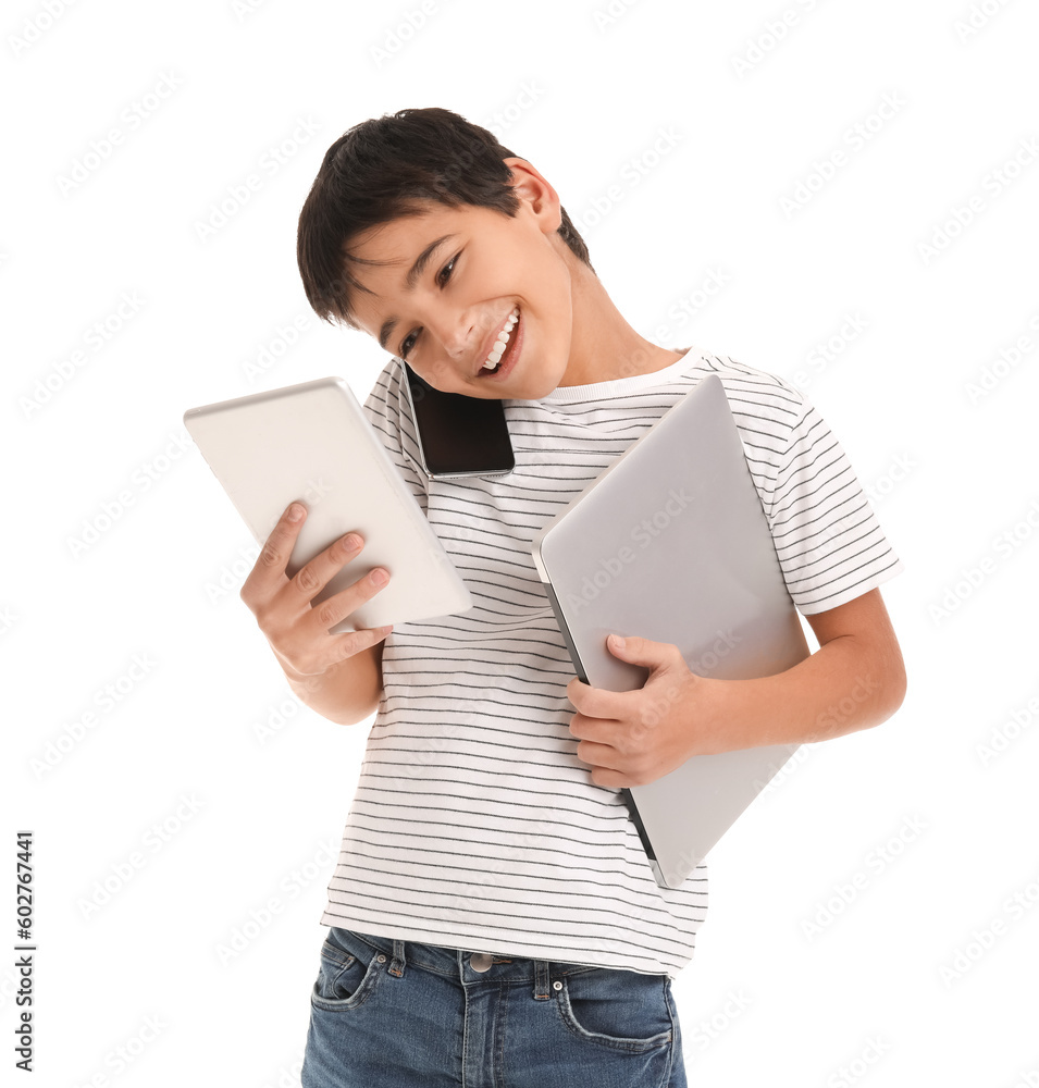Little boy with mobile phone, laptop and tablet computer on white background Little boy with mobile phone, laptop and tablet computer on white background