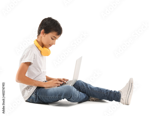 Little boy using laptop on white background