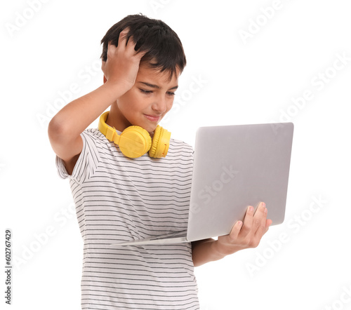 Stressed little boy using laptop on white background
