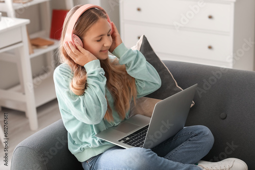 Little girl in headphones w...
