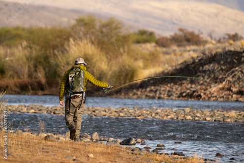 Pescador con mosca en rio patagonico photo