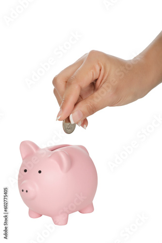 Woman placing a quarter into a piggy bank isolated on a white background