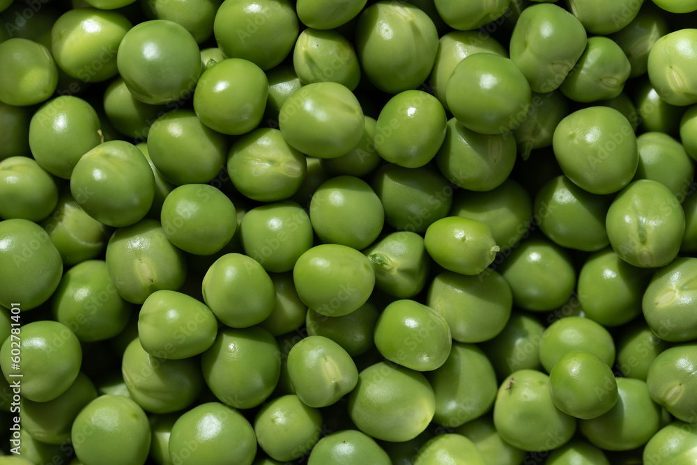 Background from many freshly peeled peas. The peas are green and lie next to each other. Background from many freshly peeled peas. The peas are green and lie next to each other.