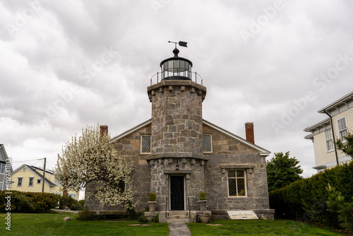The Lighthouse Museum, built in 1840 with a lighthouse tower attached to a dwelling, is located at the harbor entrance in Stonington, Connecticut. photo