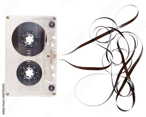 Cassette tape with unrolled tape for recording sounds and music. Isolated background.