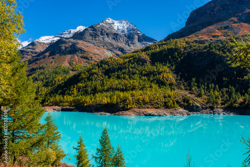 Autumnal landscape of the Lake Place Moulin  an artificial glacial lake with turquoise water in the italian Alps   on the border with Switzerland