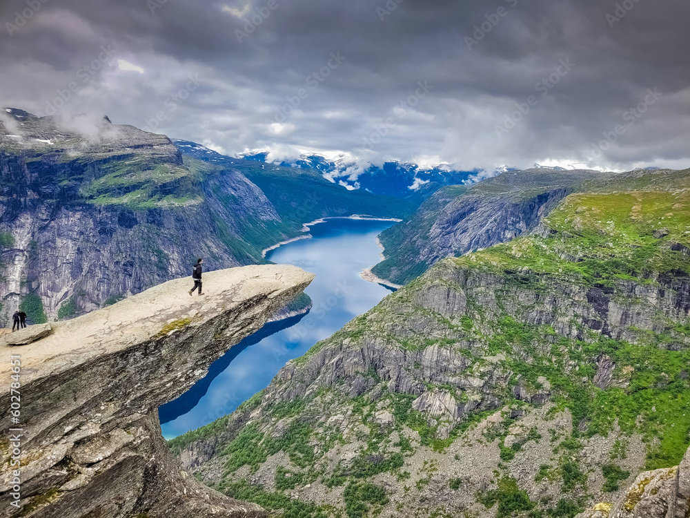 Hiker on the top of Trolltunga scenic spot , Norway