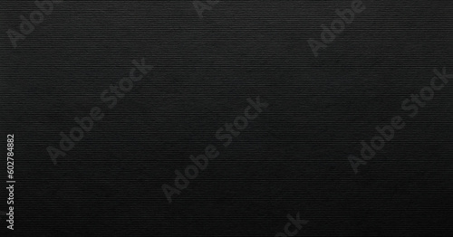 Corrugated black paper with horizontal lined texture.