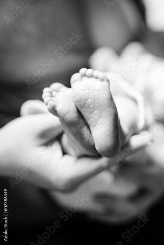 A close-up of adorable baby feet and pads of feet in black and white. 