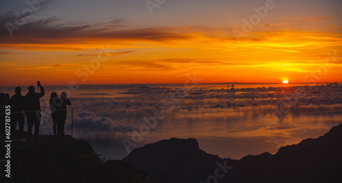 Silhouette of People watching Sunrise above clouds II.