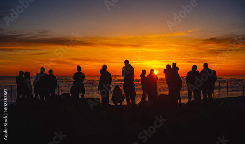 Silhouette of People watching Sunrise above clouds I.