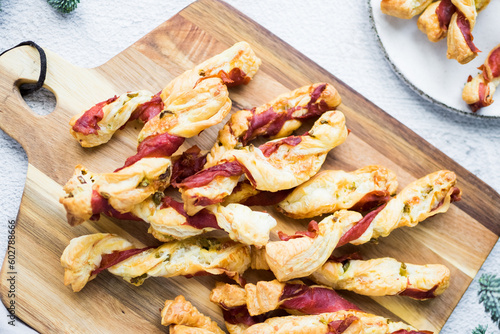 Puff pastry sticks. Close-up of puff pastry with prosciutto.