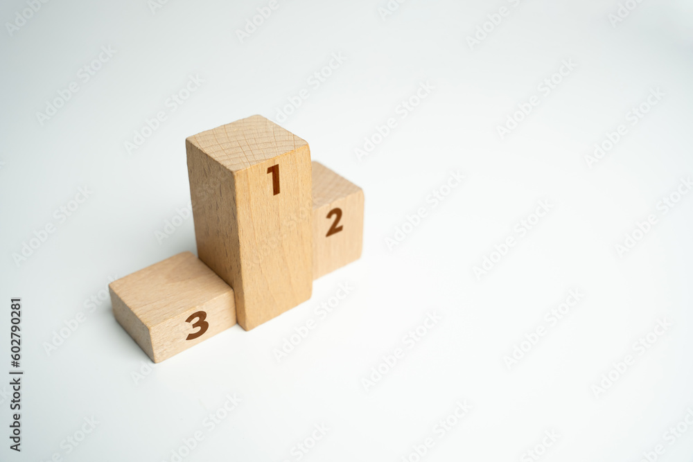 Fototapeta premium First, second and third place in the competition. Stand podium made of wooden blocks. Competition concept. Summing up the results of contest. Evaluation of the best ideas or products after review.