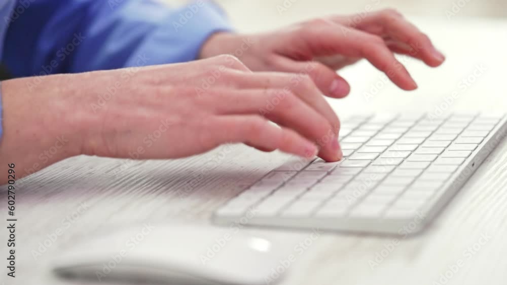 Female typing text on white keyboard. Close up Female typing text on white keyboard. Close up