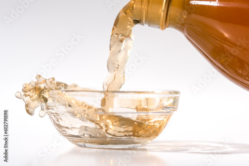 Pouring Apple Cider Vinegar in a Bowl