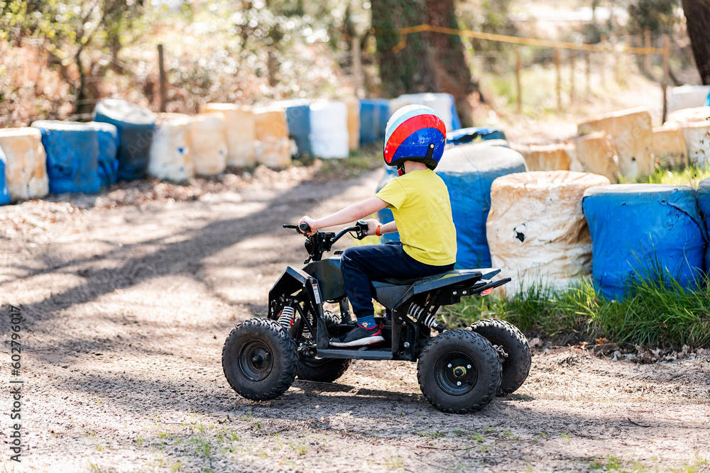 Kid driving power bike in countryside Kid driving power bike in countryside
