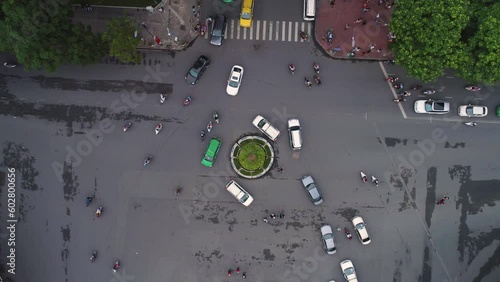 HANOI, VIETNAM - MAY, 2023: Тop aerial drone view of traffic on busy roundabout junction during daytime in Hanoi, capital of Vietnam. photo