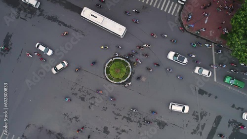 HANOI, VIETNAM - MAY, 2023: Тop aerial drone view of traffic on busy roundabout junction during daytime in Hanoi, capital of Vietnam. photo